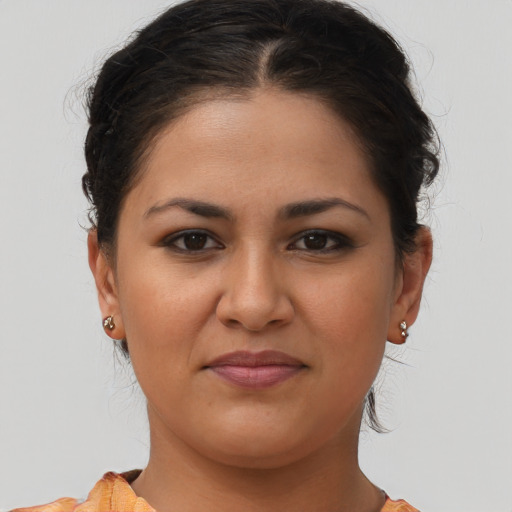 Joyful latino young-adult female with medium  brown hair and brown eyes