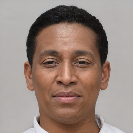 Joyful latino adult male with short  black hair and brown eyes