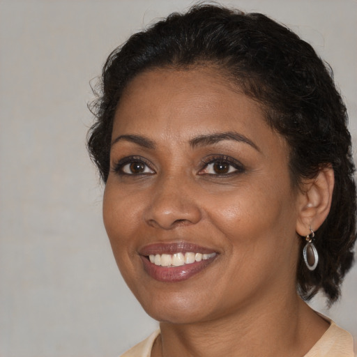Joyful black adult female with short  brown hair and brown eyes