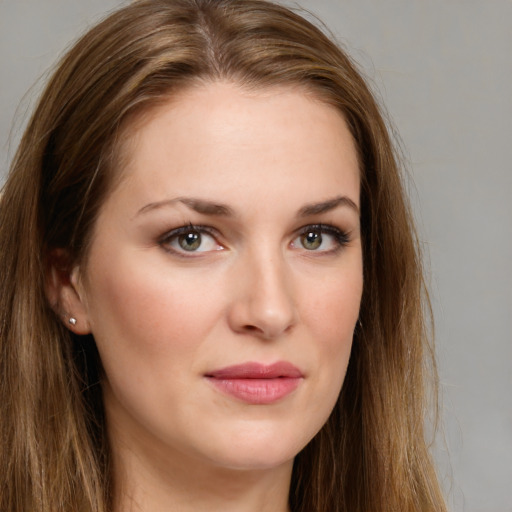 Joyful white young-adult female with long  brown hair and grey eyes