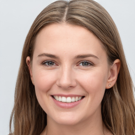 Joyful white young-adult female with long  brown hair and blue eyes