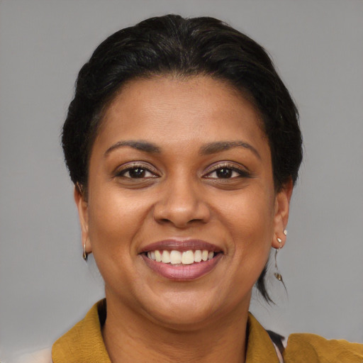 Joyful latino adult female with short  brown hair and brown eyes