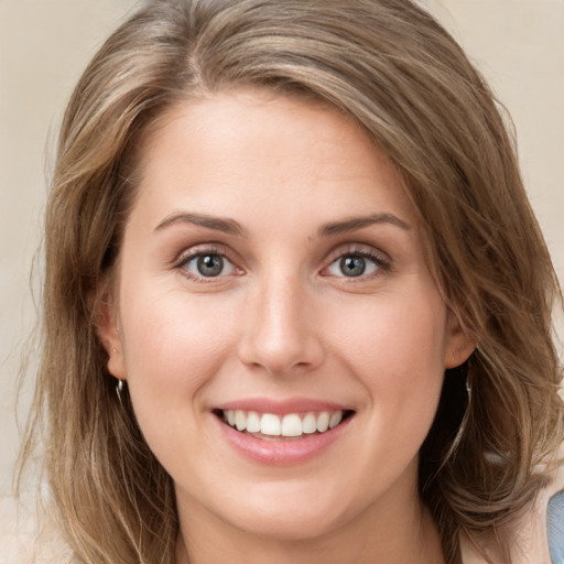 Joyful white young-adult female with medium  brown hair and green eyes