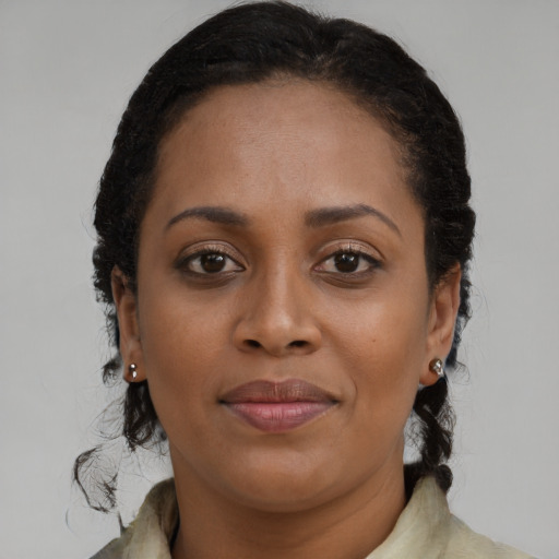 Joyful black young-adult female with medium  brown hair and brown eyes