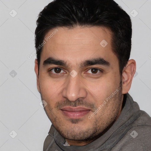 Joyful white young-adult male with short  black hair and brown eyes