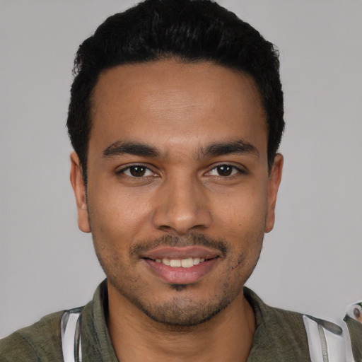 Joyful latino young-adult male with short  black hair and brown eyes