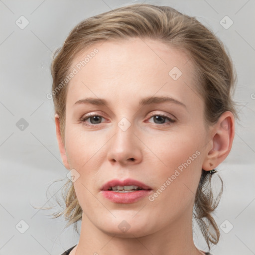 Joyful white young-adult female with medium  brown hair and blue eyes