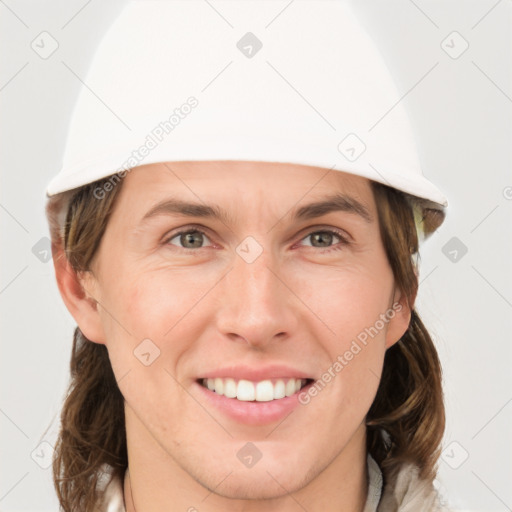 Joyful white adult female with medium  brown hair and grey eyes