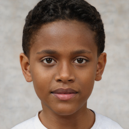 Joyful black child male with short  brown hair and brown eyes