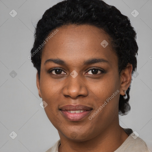 Joyful black young-adult female with short  black hair and brown eyes