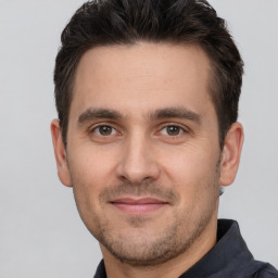 Joyful white young-adult male with short  brown hair and brown eyes