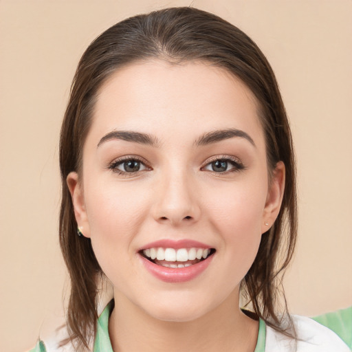 Joyful white young-adult female with medium  brown hair and brown eyes