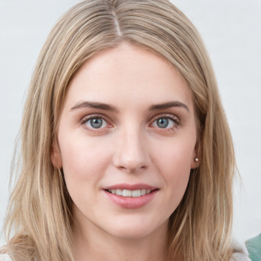 Joyful white young-adult female with long  brown hair and blue eyes