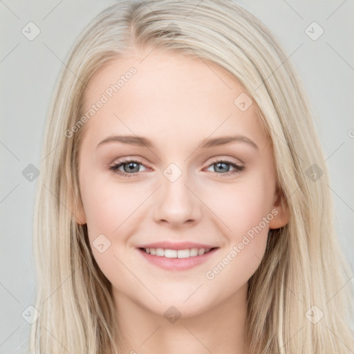 Joyful white young-adult female with long  brown hair and blue eyes