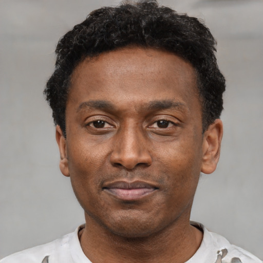 Neutral black adult male with short  black hair and brown eyes
