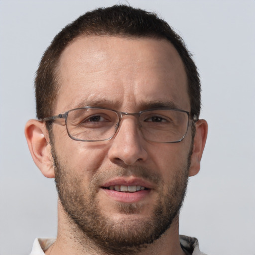 Joyful white adult male with short  brown hair and brown eyes