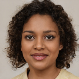 Joyful black young-adult female with medium  brown hair and brown eyes