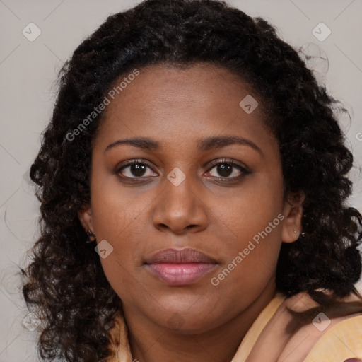 Joyful black young-adult female with long  brown hair and brown eyes