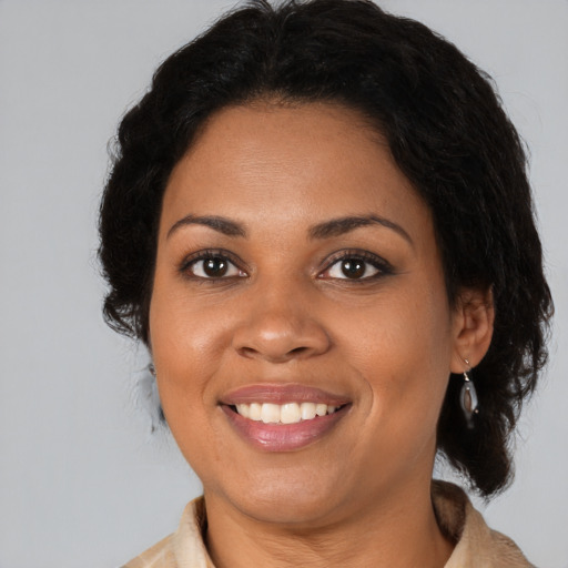 Joyful black young-adult female with medium  brown hair and brown eyes