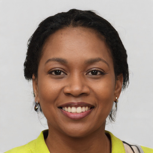 Joyful latino young-adult female with short  black hair and brown eyes