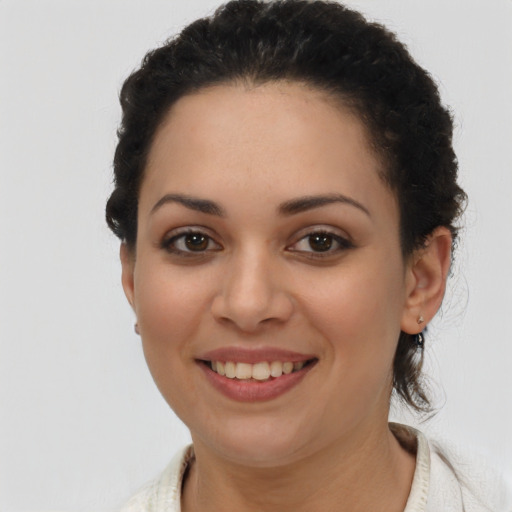 Joyful latino young-adult female with short  brown hair and brown eyes