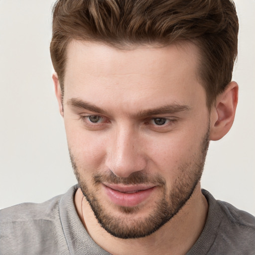 Joyful white young-adult male with short  brown hair and grey eyes