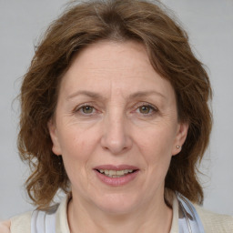 Joyful white adult female with medium  brown hair and blue eyes