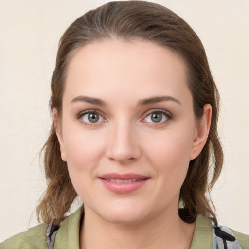 Joyful white young-adult female with medium  brown hair and green eyes