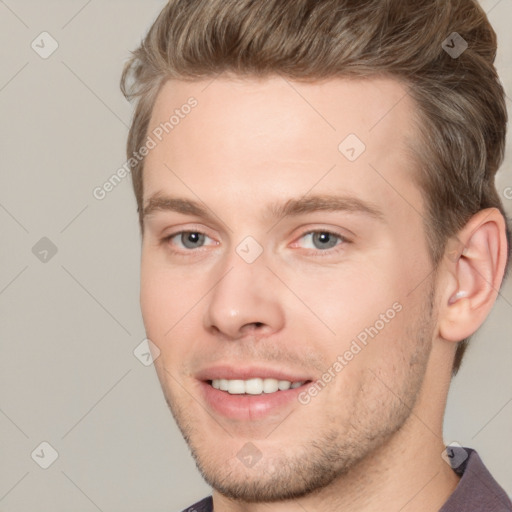 Joyful white young-adult male with short  brown hair and grey eyes