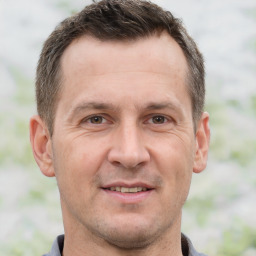 Joyful white adult male with short  brown hair and brown eyes