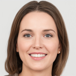 Joyful white young-adult female with long  brown hair and green eyes