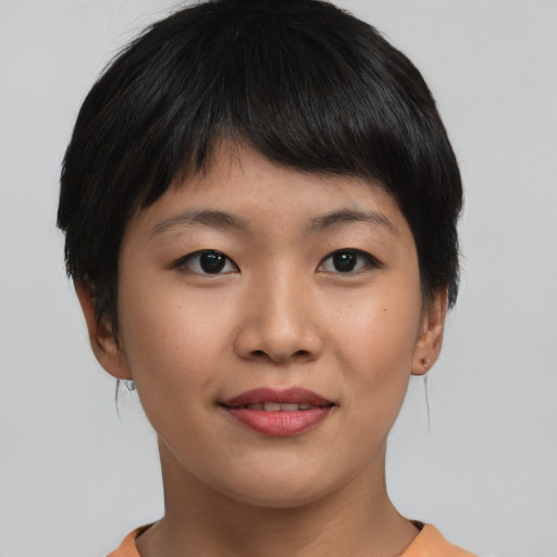 Joyful asian young-adult female with short  brown hair and brown eyes