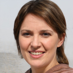 Joyful white adult female with medium  brown hair and brown eyes