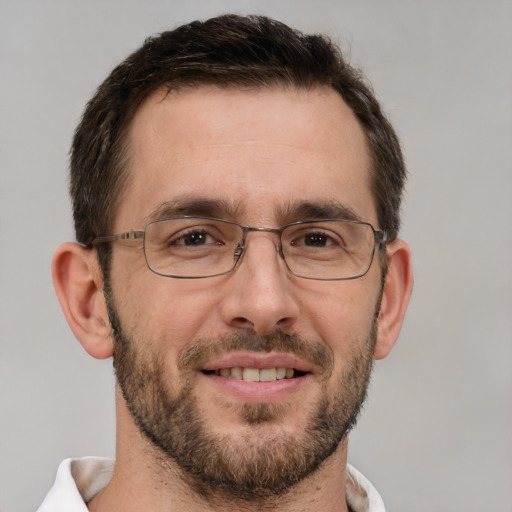 Joyful white adult male with short  brown hair and brown eyes