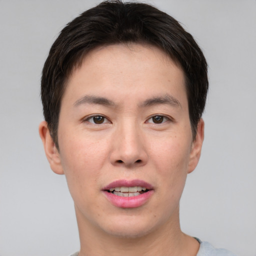 Joyful asian young-adult male with short  brown hair and brown eyes