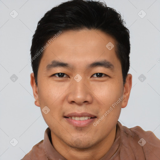 Joyful asian young-adult male with short  black hair and brown eyes