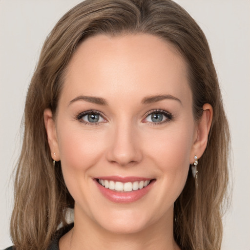 Joyful white young-adult female with long  brown hair and grey eyes