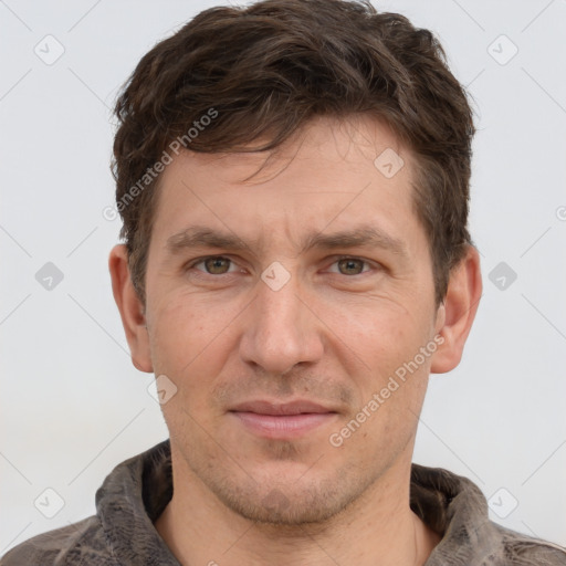 Joyful white adult male with short  brown hair and grey eyes