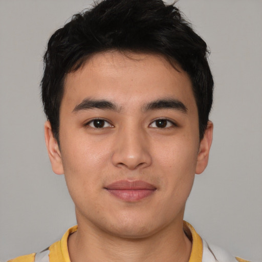 Joyful asian young-adult male with short  brown hair and brown eyes