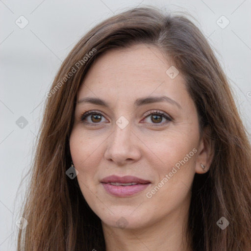 Joyful white adult female with long  brown hair and brown eyes