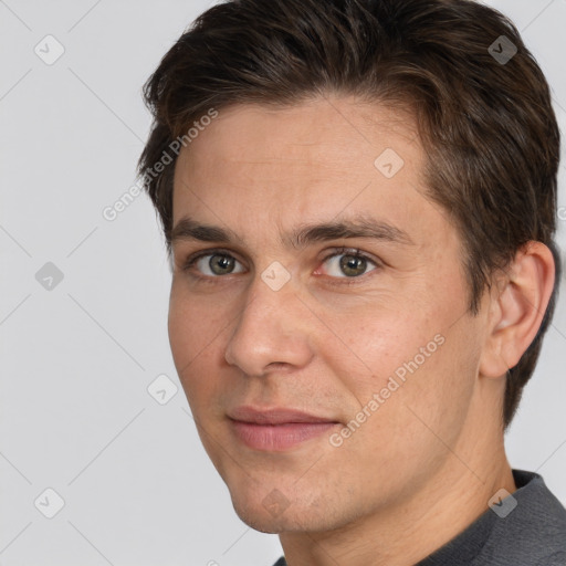 Joyful white adult male with short  brown hair and brown eyes