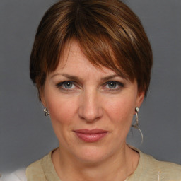 Joyful white adult female with medium  brown hair and grey eyes