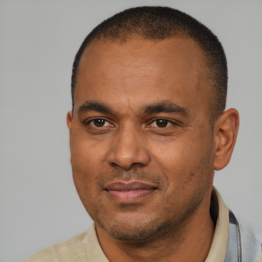 Joyful latino adult male with short  brown hair and brown eyes