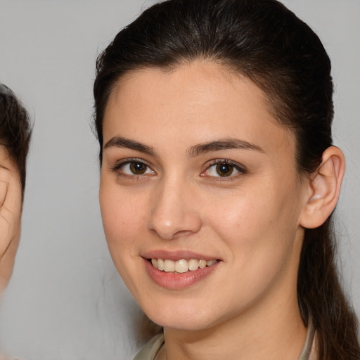 Joyful white young-adult female with medium  brown hair and brown eyes