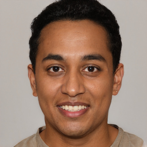 Joyful black young-adult male with short  black hair and brown eyes