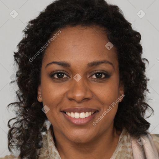 Joyful black young-adult female with long  brown hair and brown eyes