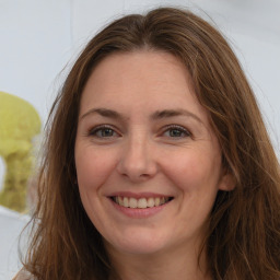 Joyful white adult female with long  brown hair and brown eyes