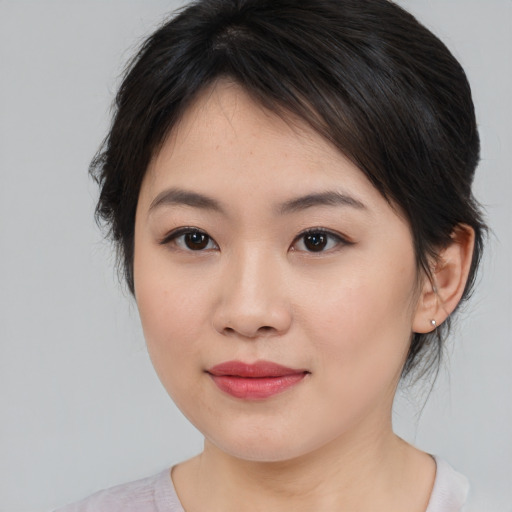 Joyful asian young-adult female with medium  brown hair and brown eyes