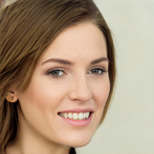 Joyful white young-adult female with long  brown hair and green eyes