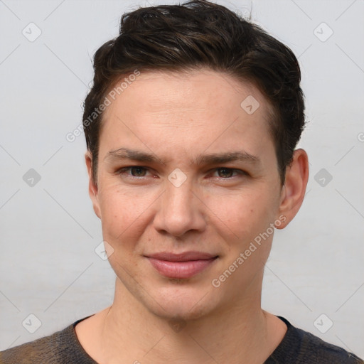 Joyful white young-adult male with short  brown hair and grey eyes